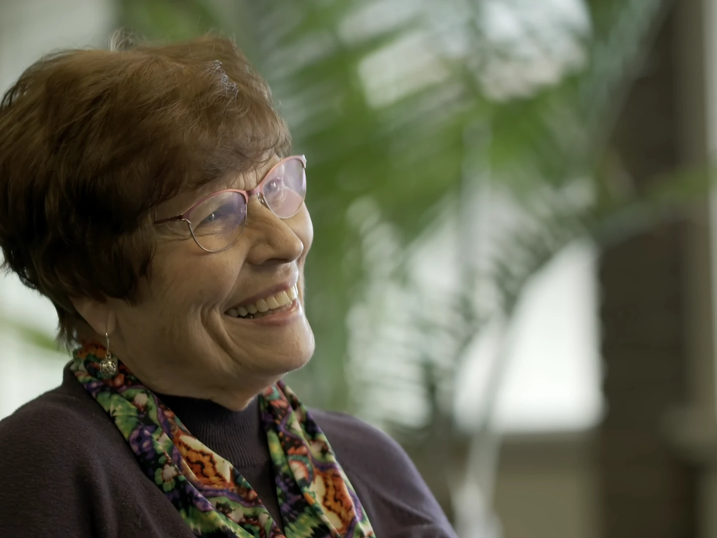 A community member laughing during an interview, shot with available light